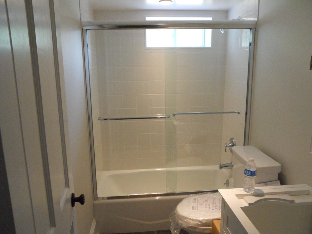 Frameless Double Sliding Tub Enclosure by Absolute Shower Doors